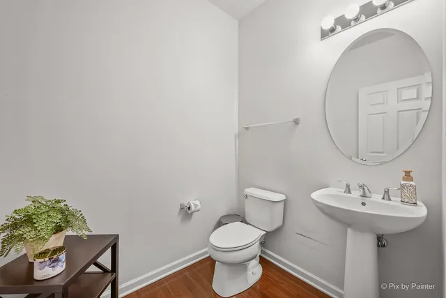 a bathroom with a sink toilet and a mirror