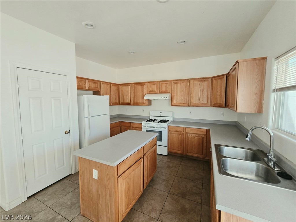 9034 West Rochelle Avenue Las Vegas, NV 89147 - Photo 5 of 8 A well-equipped kitchen awaits, featuring an inviting island and ample counter space for culinary endeavors.