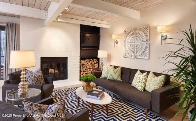 101 East Cooper Avenue, Unit 202 Aspen, CO 81611 - Photo 2 of 7 a living room with furniture and a fireplace