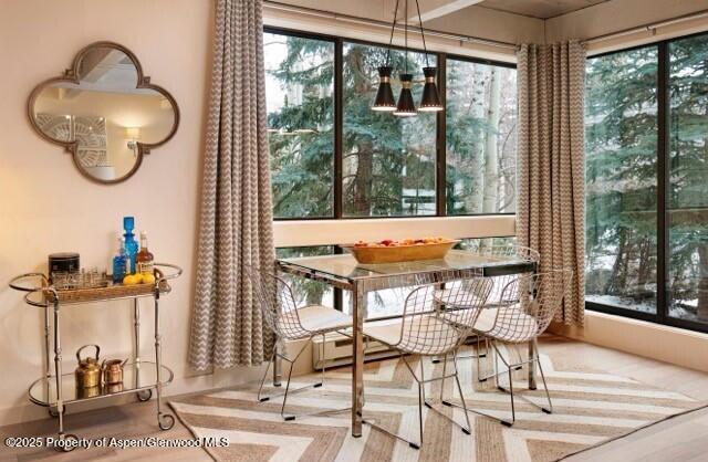 101 East Cooper Avenue, Unit 202 Aspen, CO 81611 - Photo 3 of 7 a view of a dining room with furniture window and outside view