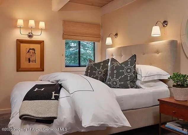 a living room with a bed furniture and a window