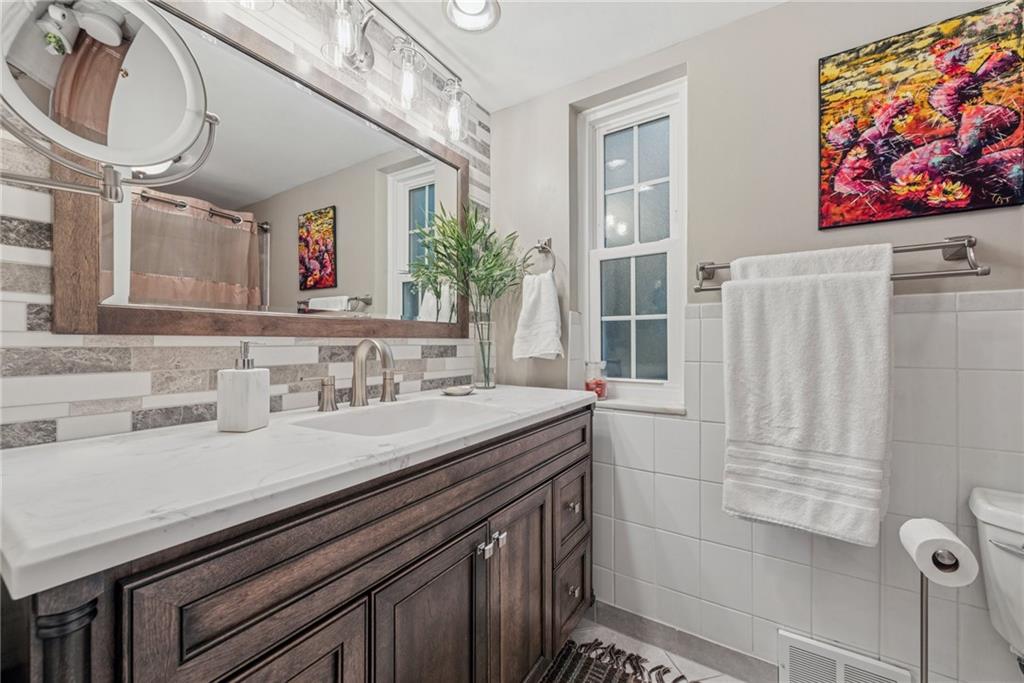 118 Conewanta Road Pittsburgh, PA 15241 - Photo 32 of 48 a bathroom with a sink a vanity and a window