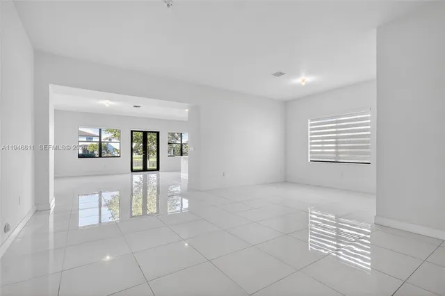 a kitchen with a sink a microwave and cabinets