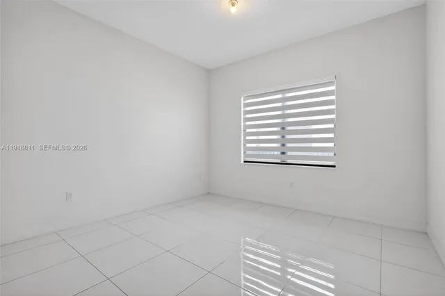 a view of a house with a small yard and a garden