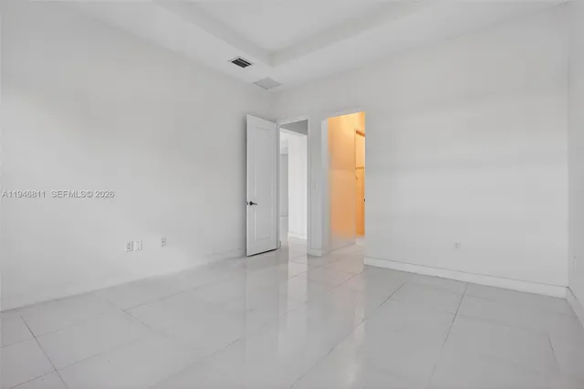 a bathroom with a toilet a sink a mirror and shower