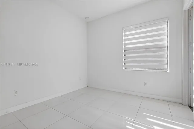 an aerial view of a city with lots of residential buildings and ocean view