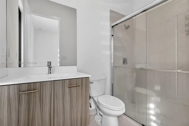 an aerial view of multiple houses with a yard