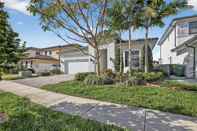 a front view of a house with a garden