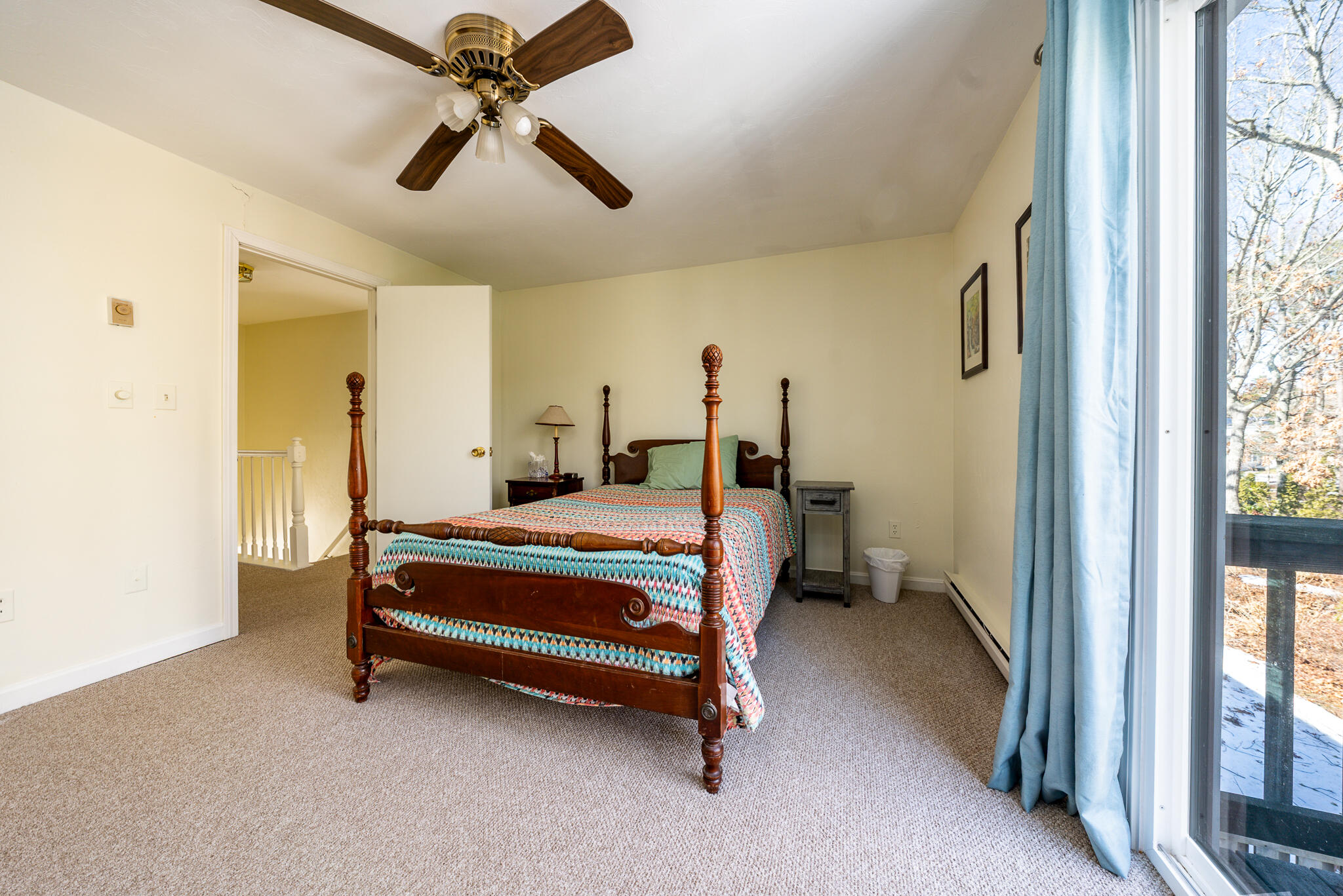 195 Falmouth Road, Unit 9F Mashpee, MA 02649 - Photo 28 of 35 a bedroom with a bed and a chandelier