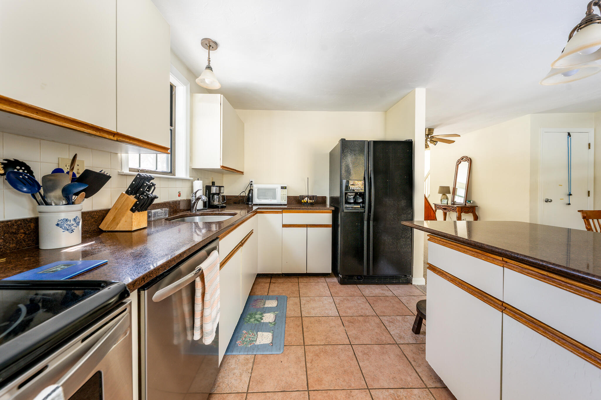 195 Falmouth Road, Unit 9F Mashpee, MA 02649 - Photo 10 of 35 a kitchen with stainless steel appliances a refrigerator sink and cabinets