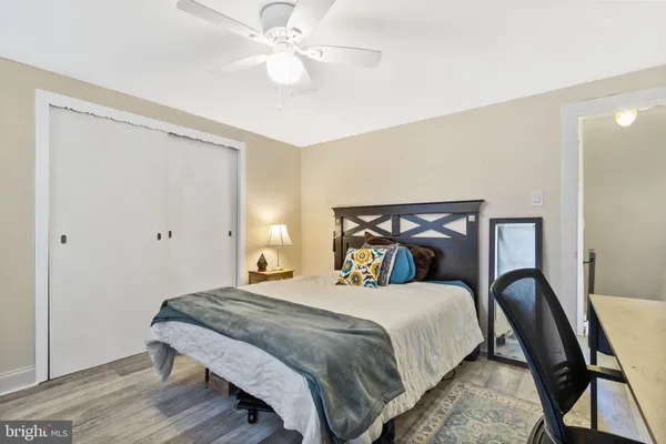 a bedroom with bed and a chandelier