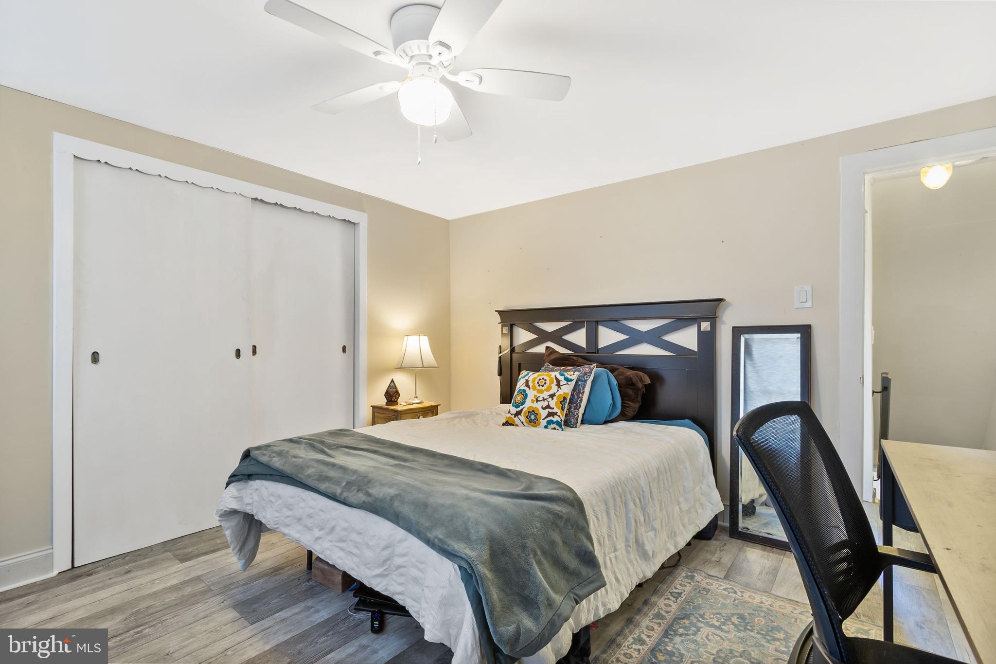 111 Thompson Street Burlington, NJ 08016 - Photo 13 of 25 a bedroom with a bed and a chandelier