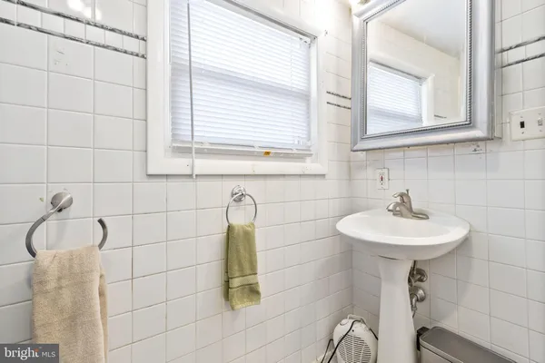 a bathroom with a sink a toilet and tub