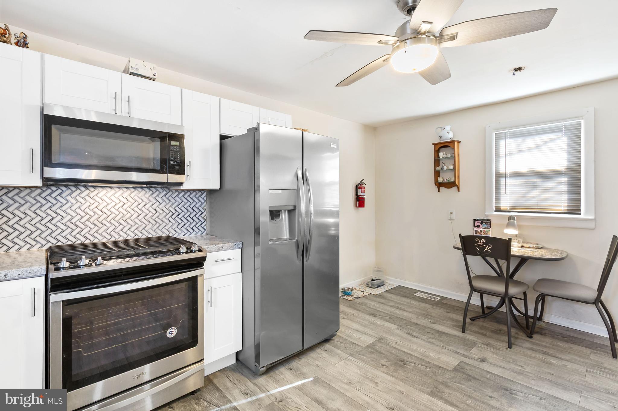 111 Thompson Street Burlington, NJ 08016 - Photo 3 of 25 a kitchen with cabinets stainless steel appliances and wooden floor