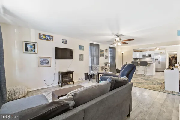 a living room with furniture a rug and a chandelier