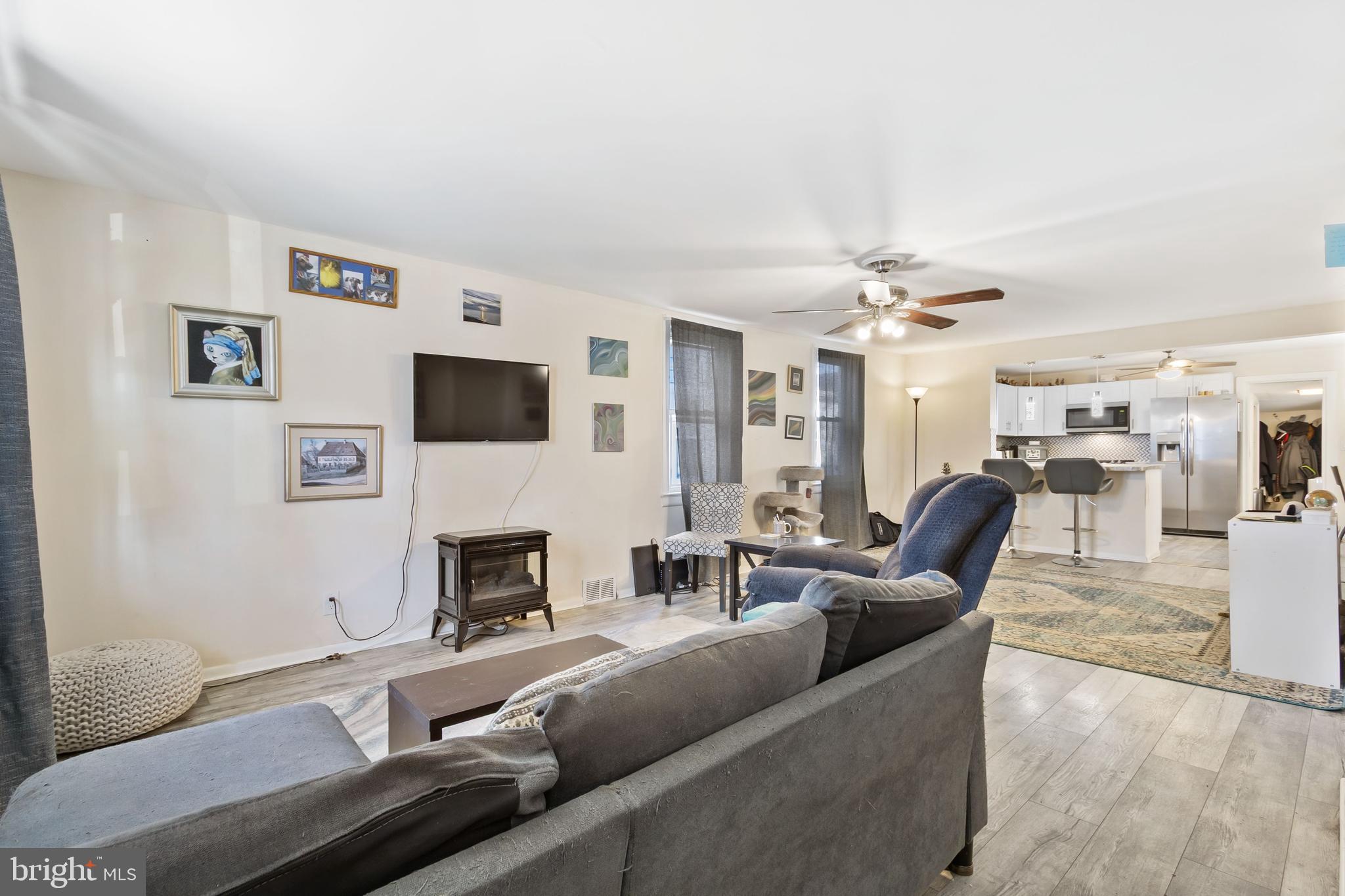 111 Thompson Street Burlington, NJ 08016 - Photo 5 of 25 a living room with fireplace furniture and a flat screen tv