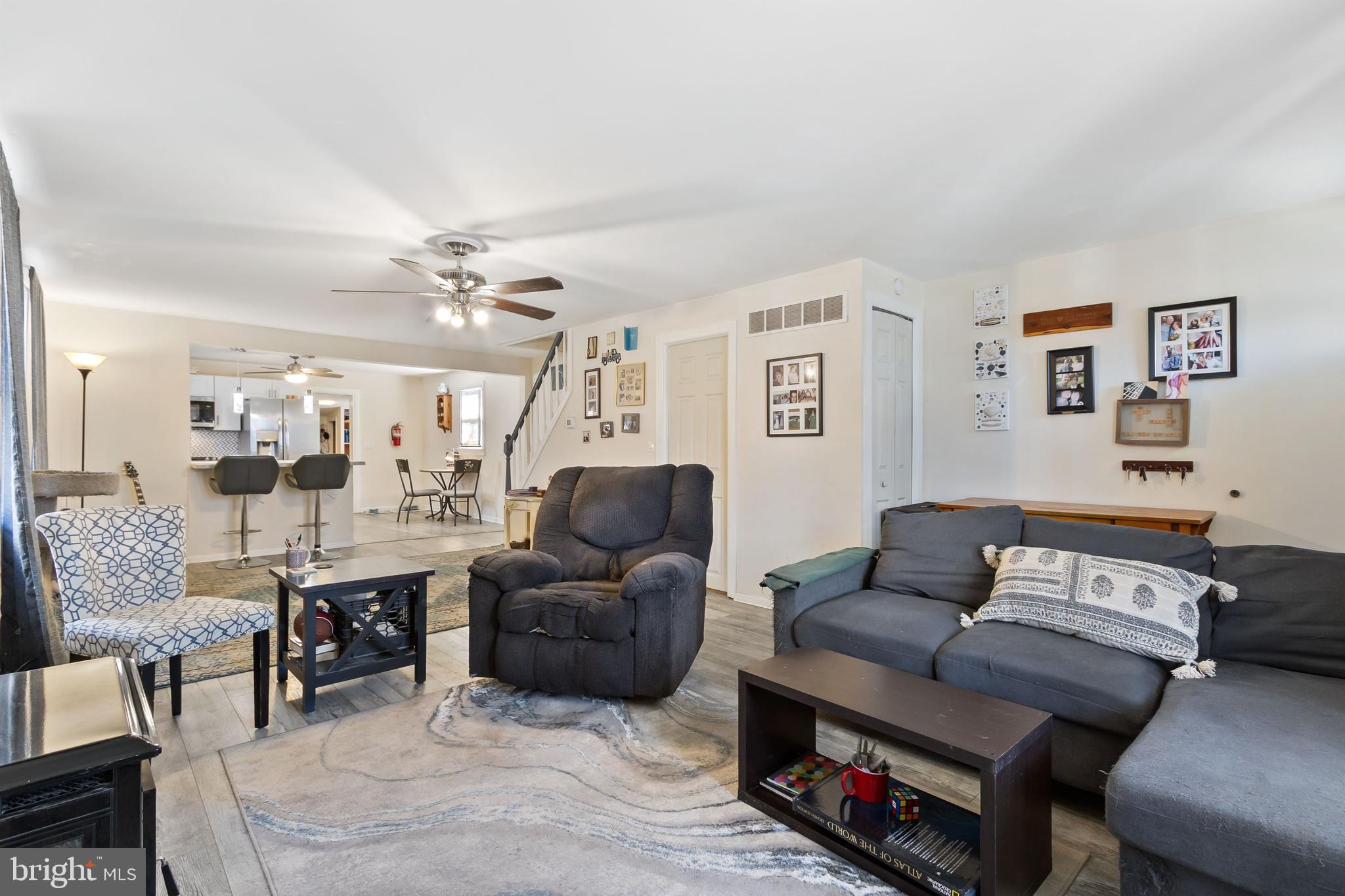 111 Thompson Street Burlington, NJ 08016 - Photo 6 of 25 a living room with furniture a rug and a chandelier