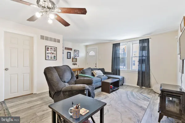 a living room with furniture a dining table and chair with the potted plants