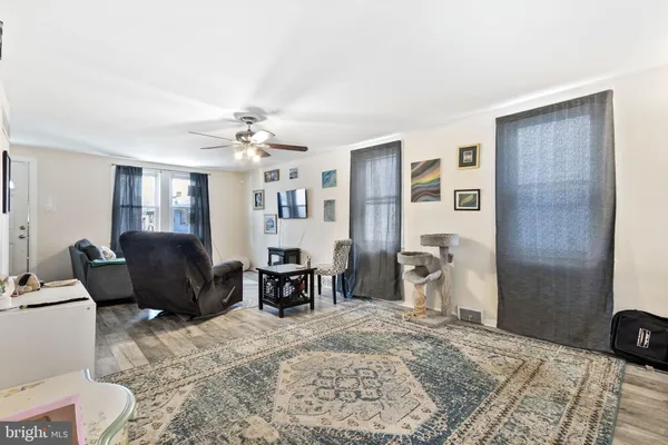 a living room with furniture and wooden floor
