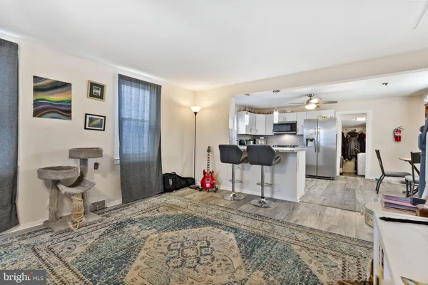 a living room with furniture and wooden floor