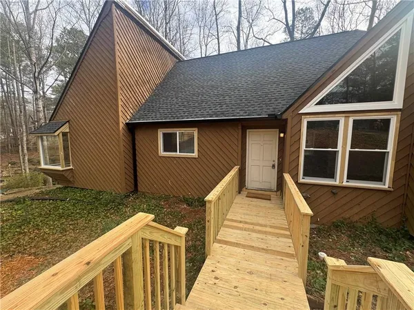 a view of a house with more wooden fence