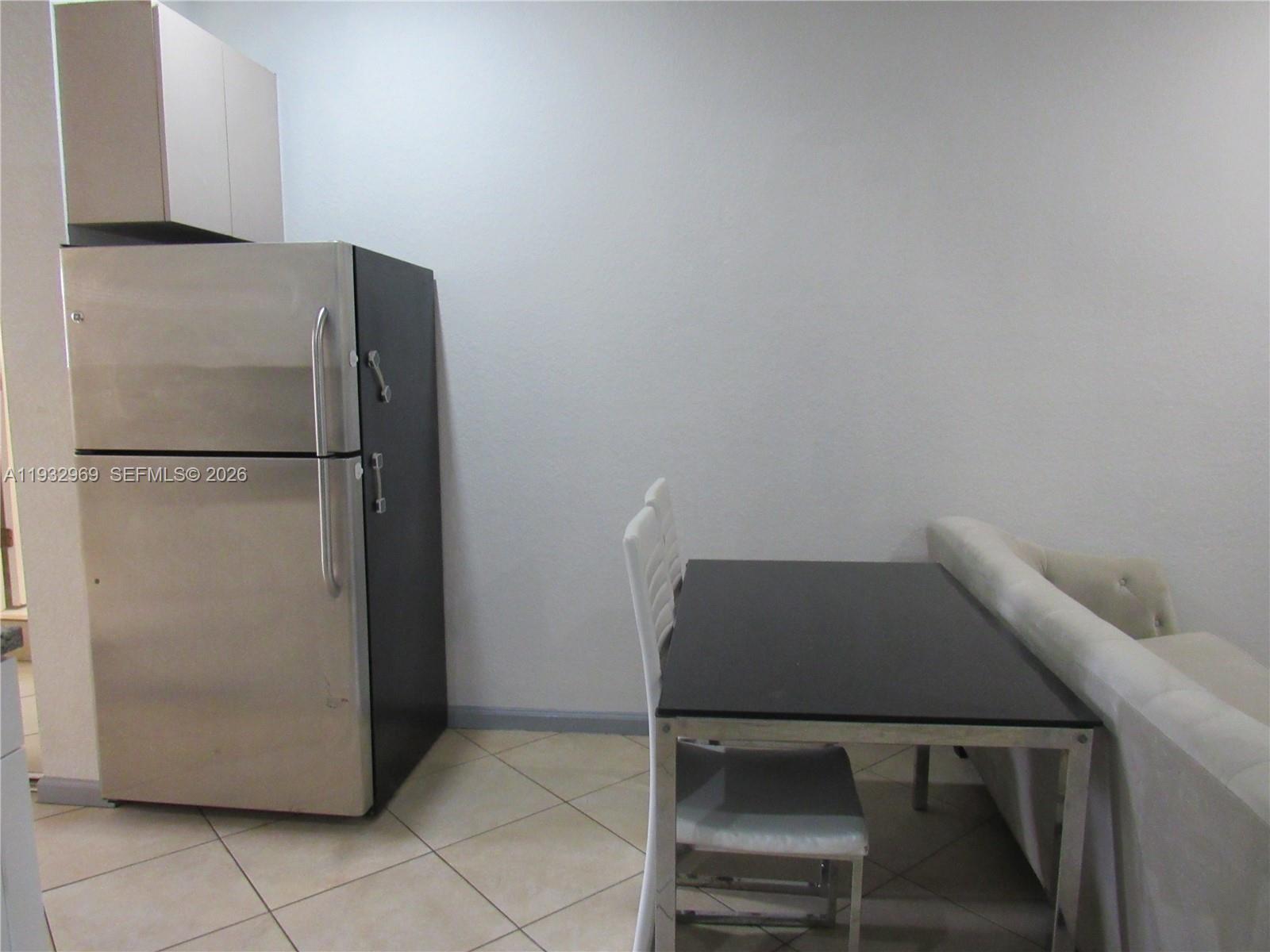 15900 Southwest 54th Place, Unit 1 Southwest Ranches, FL 33331 - Photo 8 of 15 a refrigerator freezer sitting in a kitchen