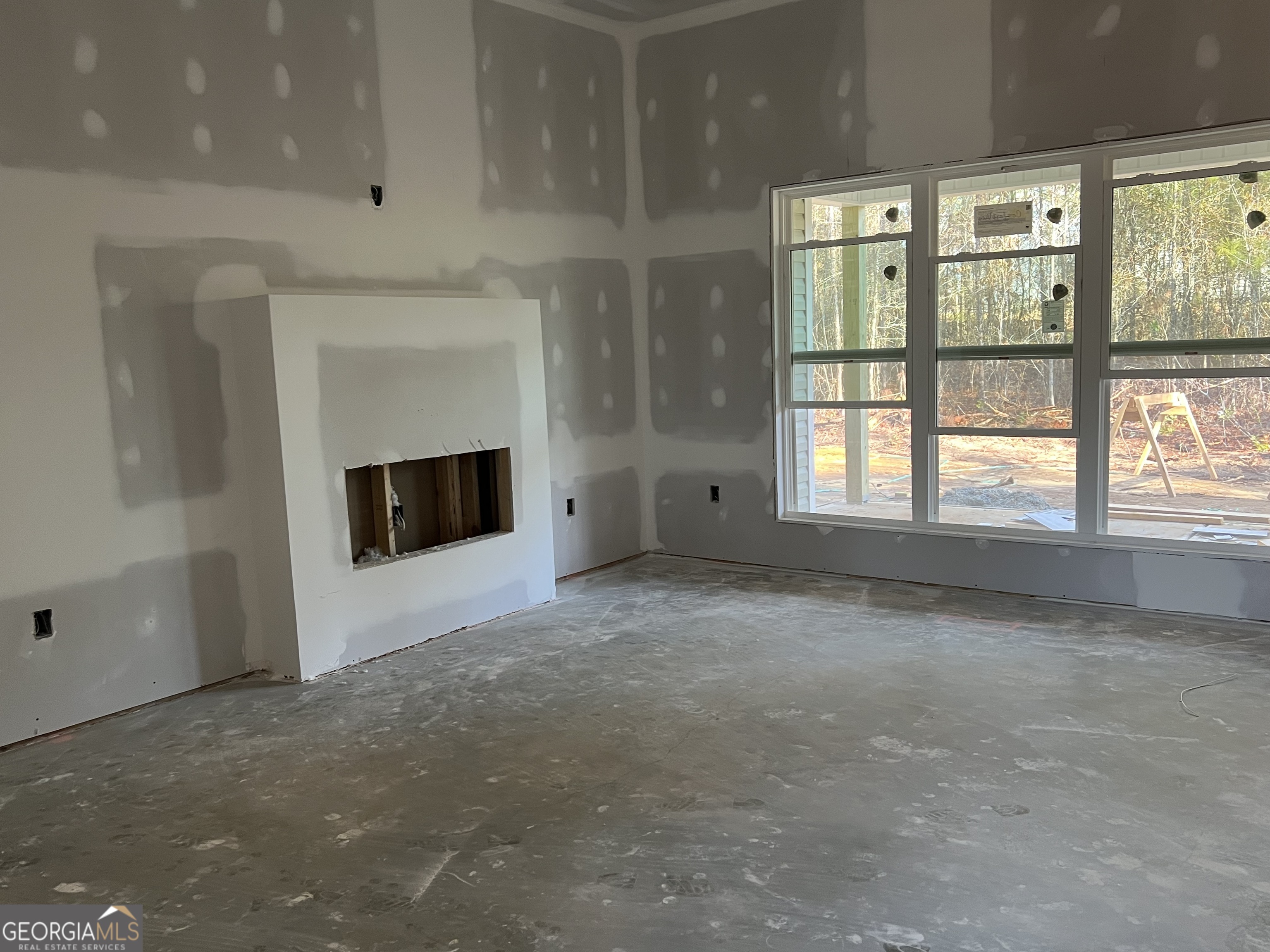 0 Flanders Court Dublin, GA 31021 - Photo 3 of 17 a view of an empty room with a fireplace and a window