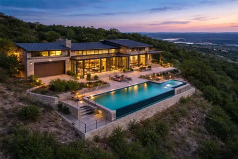 a view of a house with pool and chairs