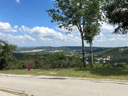 a view of a fountain with a tree in the background