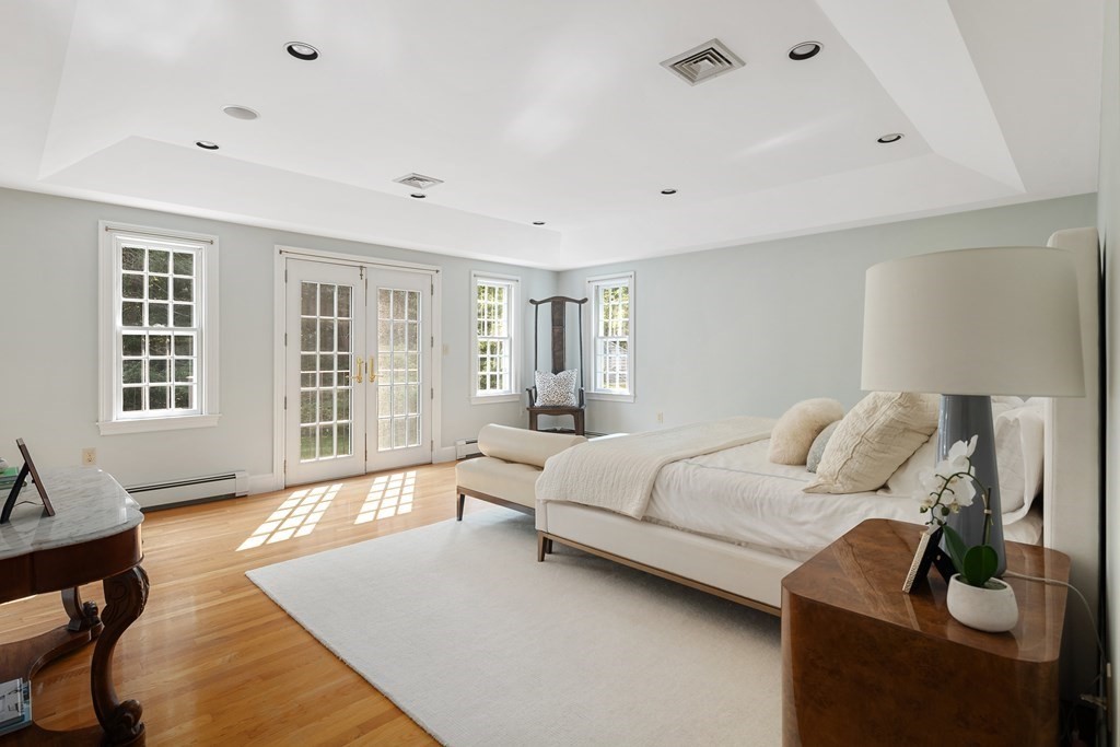 30 Arnold Road Hingham, MA 02043 - Photo 25 of 37 a bedroom with a bed and wooden floor