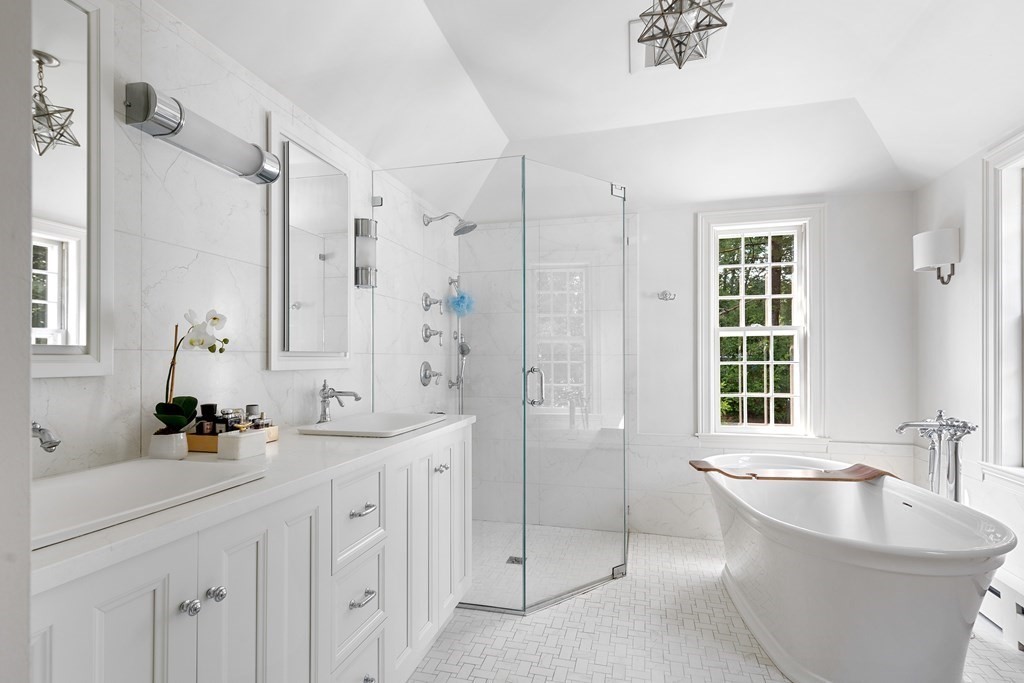 30 Arnold Road Hingham, MA 02043 - Photo 26 of 37 a bathroom with a double vanity sink window and a bathtub