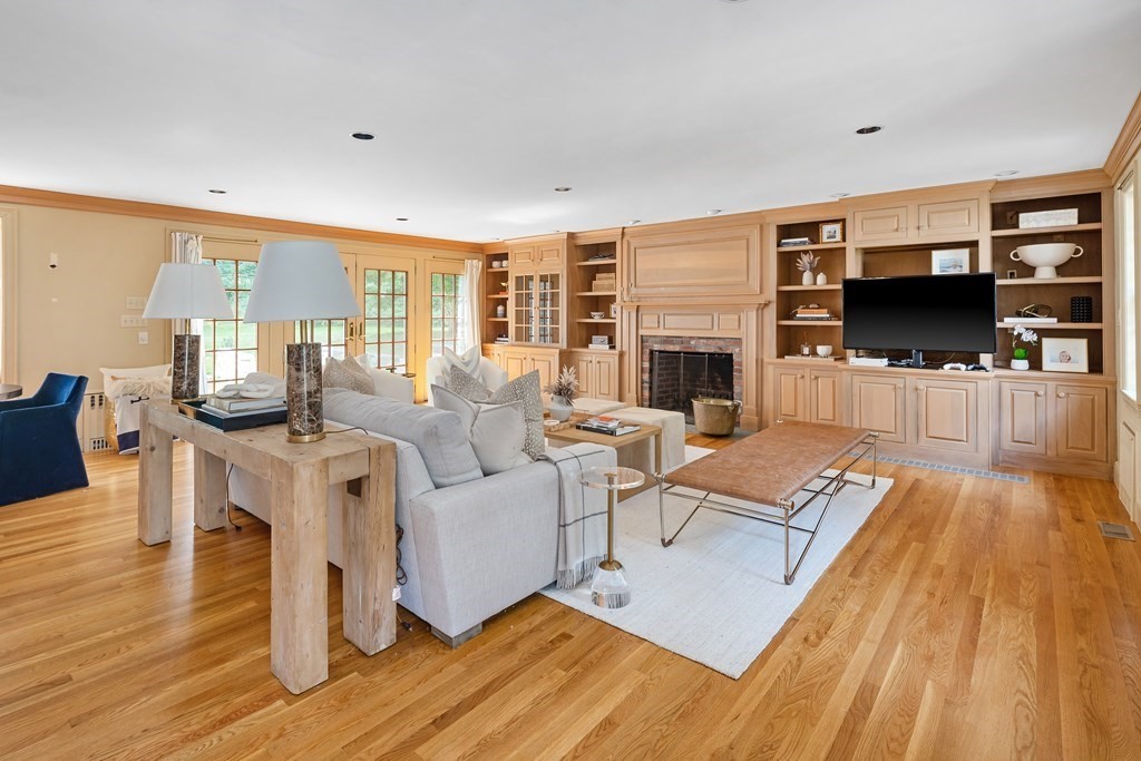 30 Arnold Road Hingham, MA 02043 - Photo 8 of 37 a living room with fireplace furniture and a flat screen tv