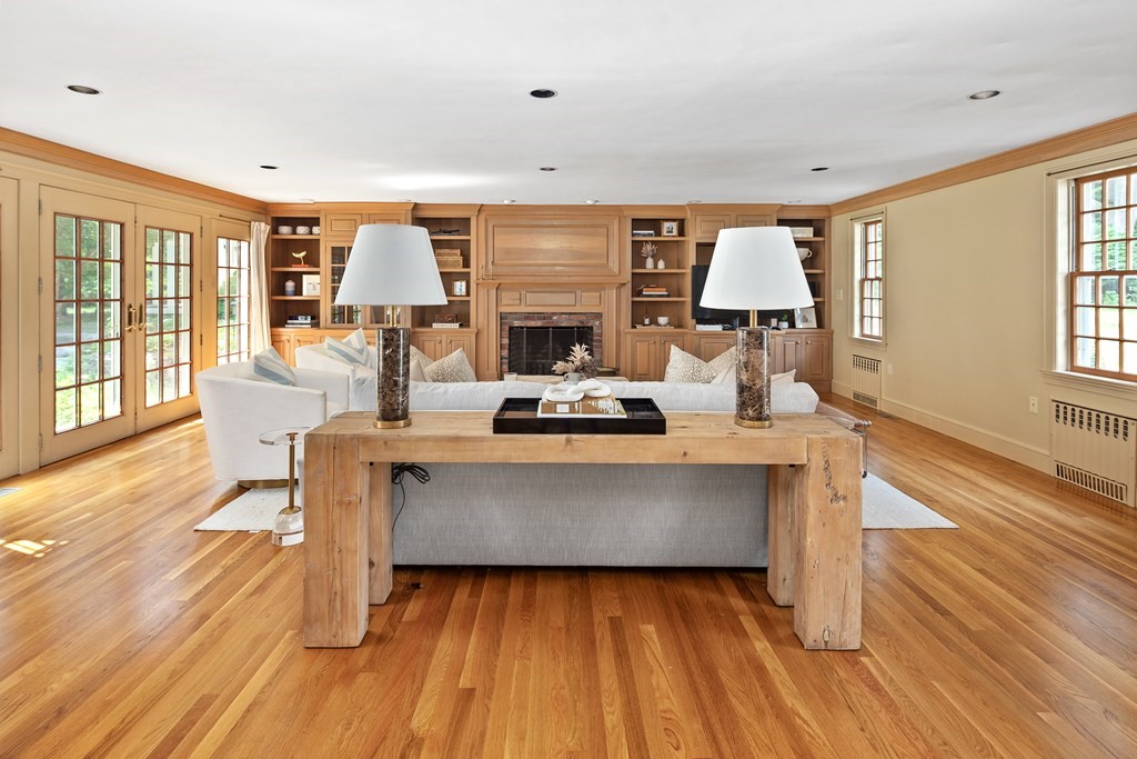 30 Arnold Road Hingham, MA 02043 - Photo 10 of 37 a living room with furniture a large window wooden floor and a rug
