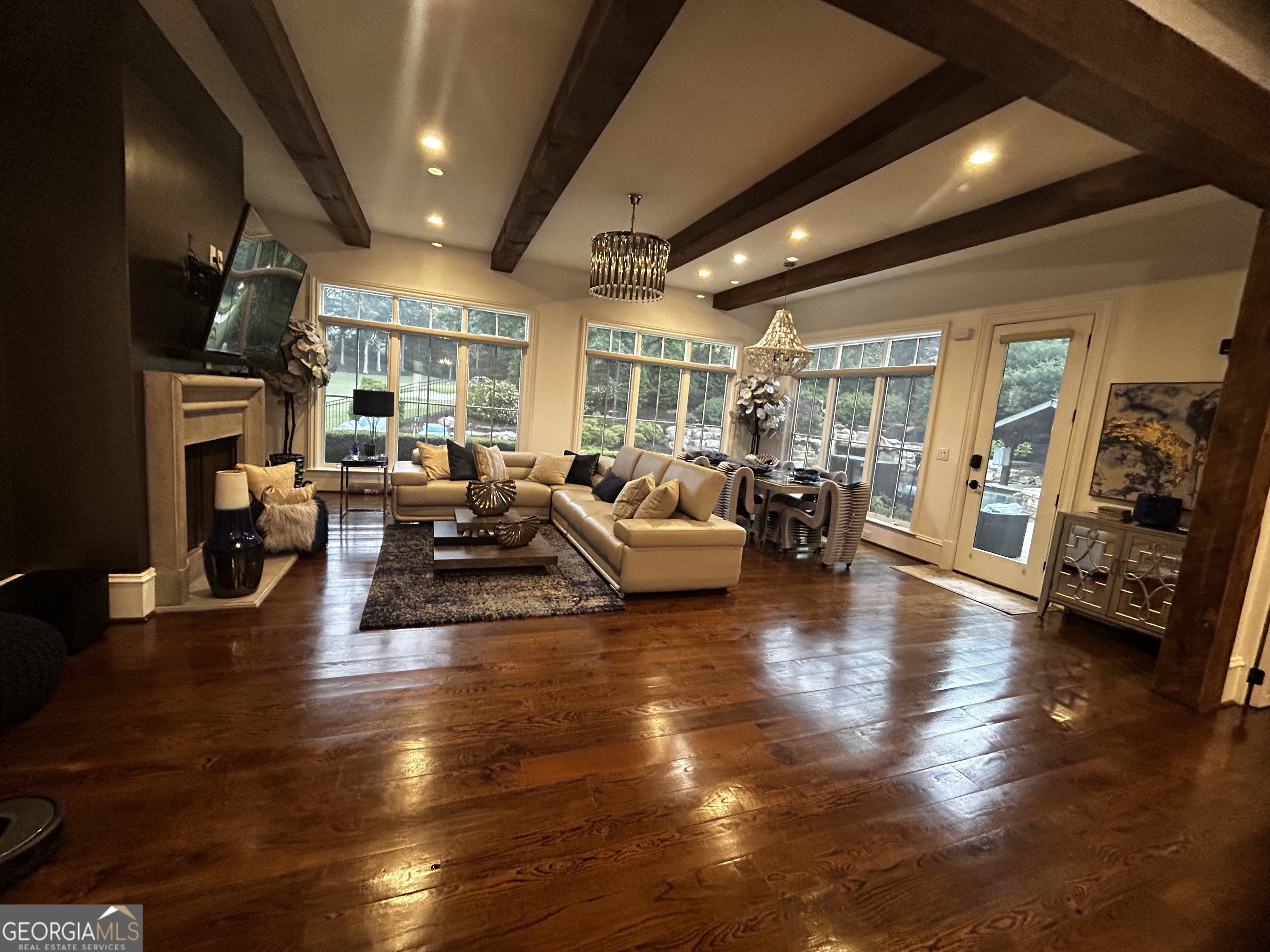 3084 Watson's Bend Milton, GA 30004 - Photo 27 of 95 a living room with fireplace furniture and a wooden floor