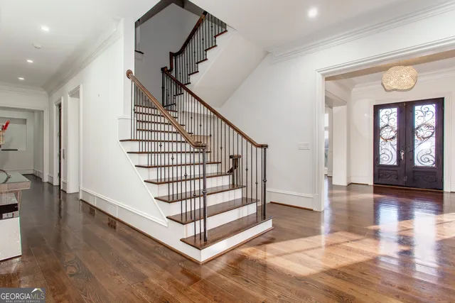 a view of an empty room with window wooden floor and fire place
