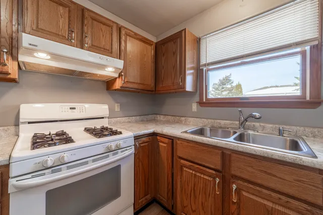a kitchen with stainless steel appliances a stove sink and cabinets