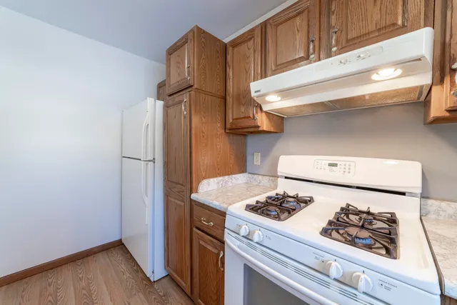 a kitchen with stainless steel appliances granite countertop a refrigerator and a stove
