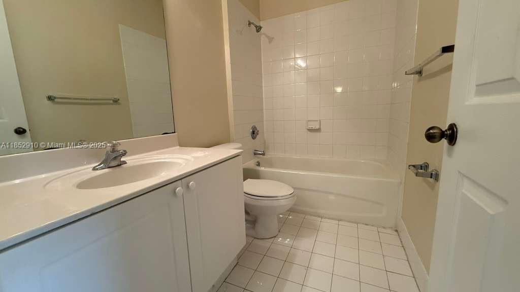 3361 Merrick Lane, Unit 808 Margate, FL 33063 - Photo 11 of 13 a bathroom with a granite countertop sink a toilet and shower