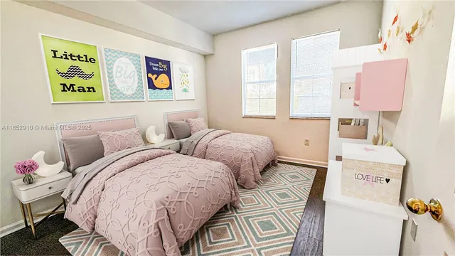 a bedroom with two beds and a desk