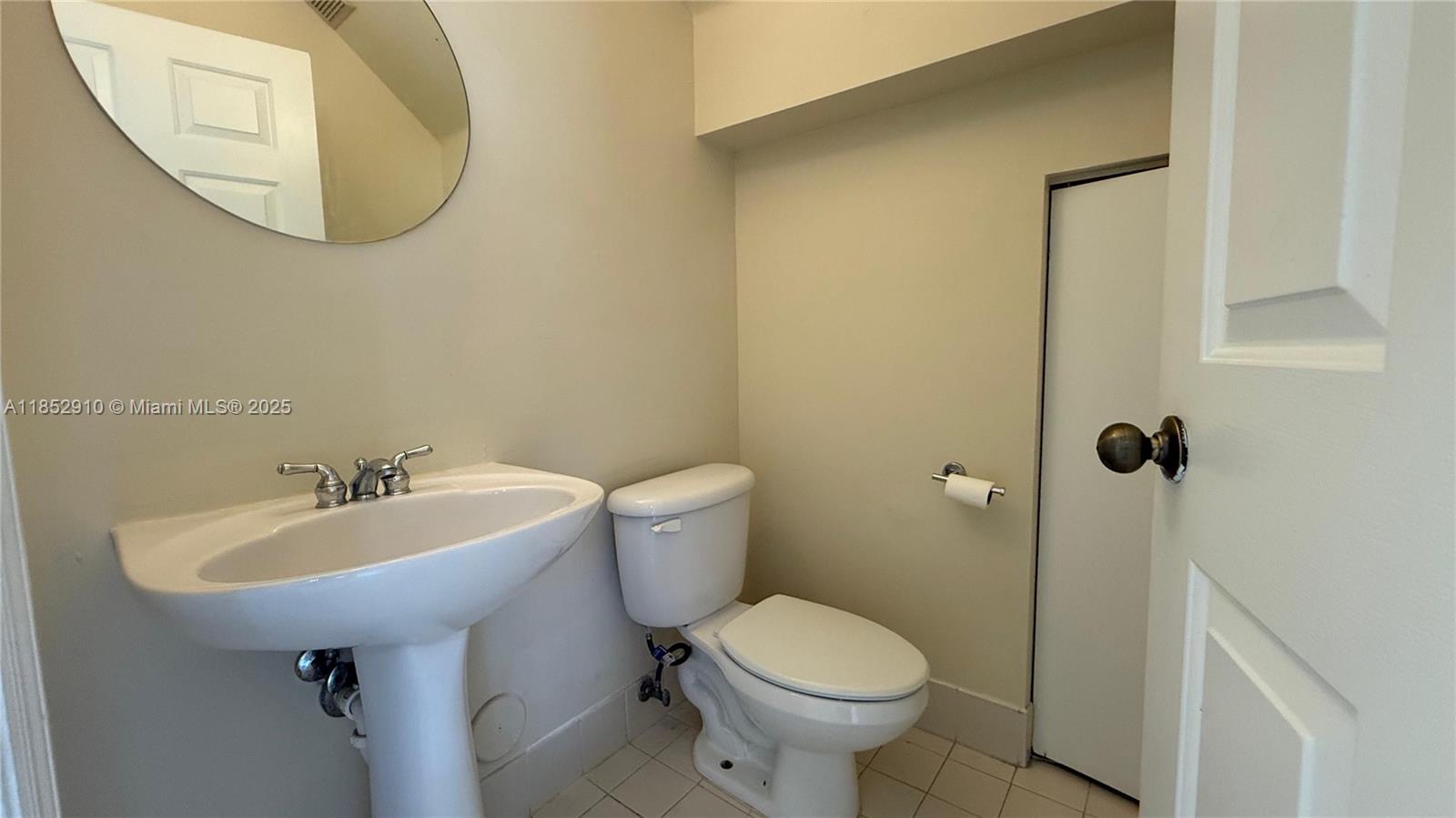 3361 Merrick Lane, Unit 808 Margate, FL 33063 - Photo 6 of 13 a bathroom with a sink toilet and a mirror