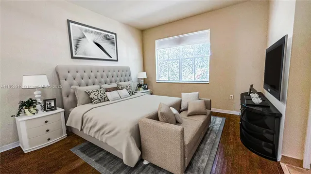 a bedroom with a bed and a flat screen tv