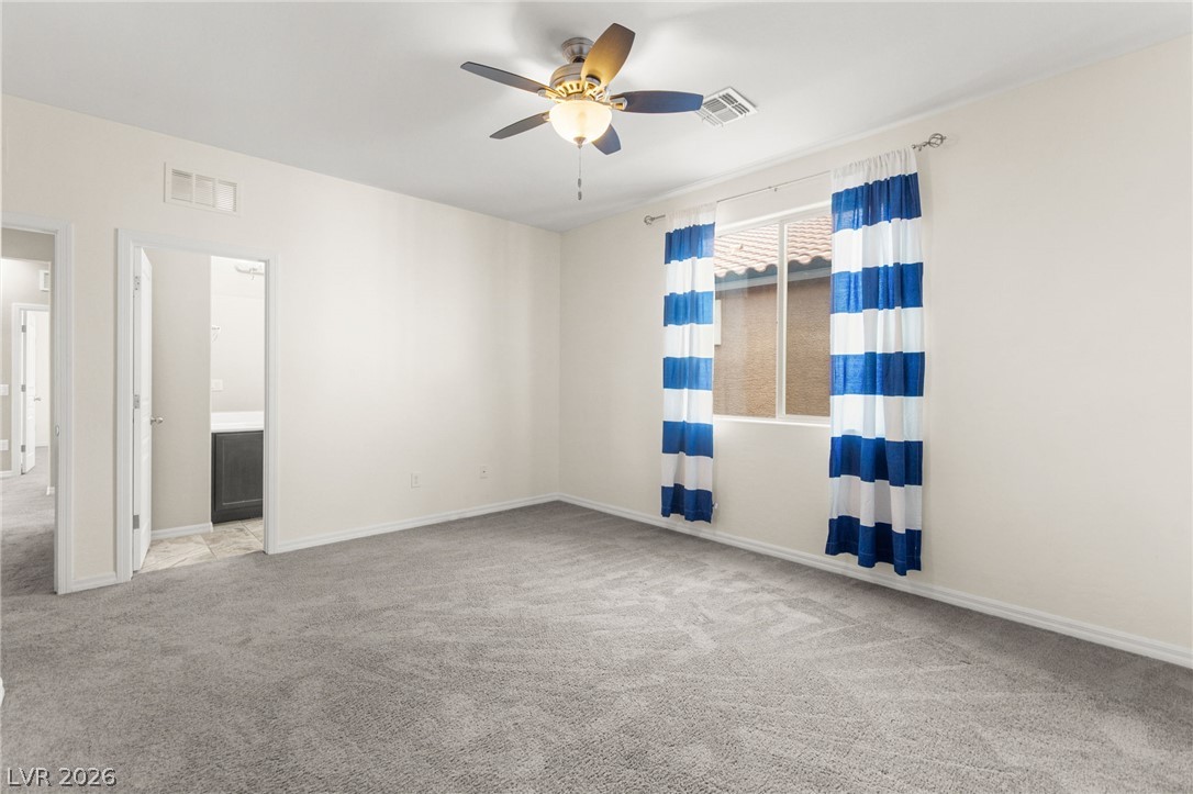 11048 Prairie Grove Road Las Vegas, NV 89179 - Photo 62 of 75 A quiet bedroom with a ceiling fan offers peaceful repose and privacy.
