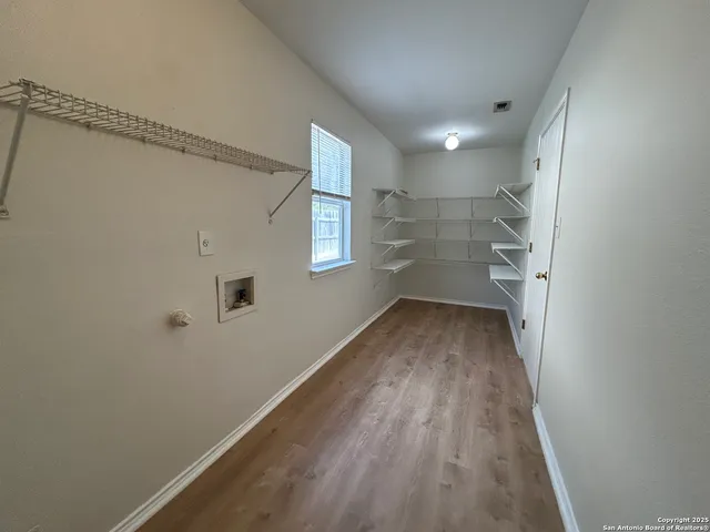 a view of a kitchen with a sink and microwave