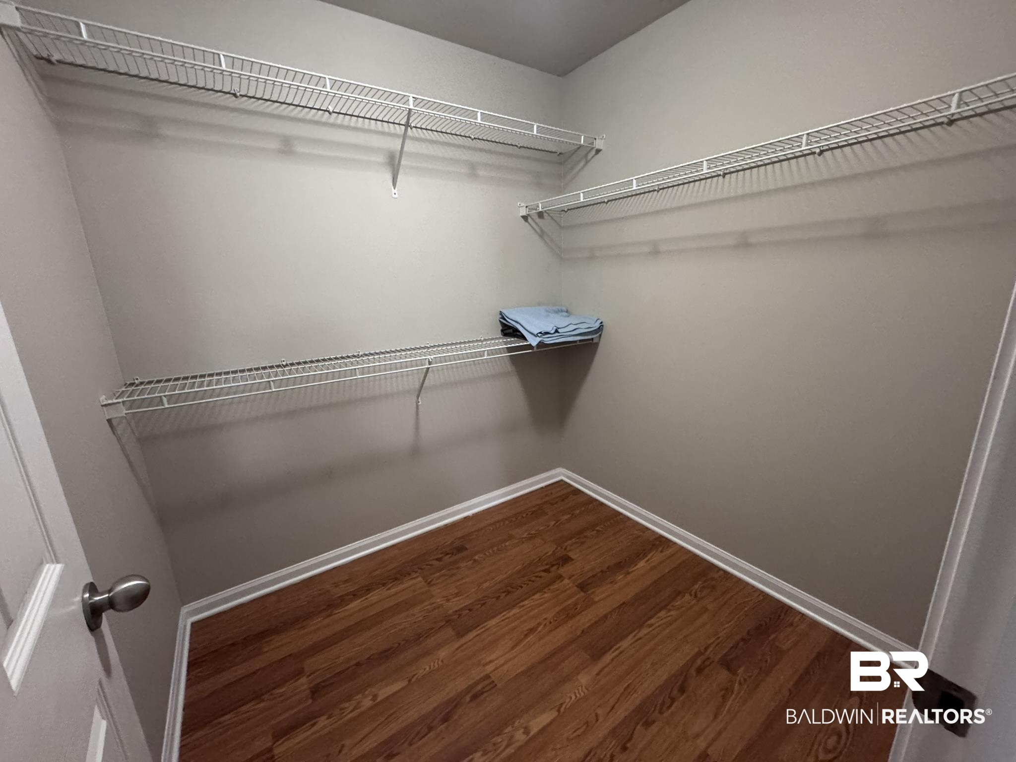 1517 Regency Road, Unit 131 Gulf Shores, AL 36542 - Photo 16 of 21 Walk in closet with dark wood finished floors