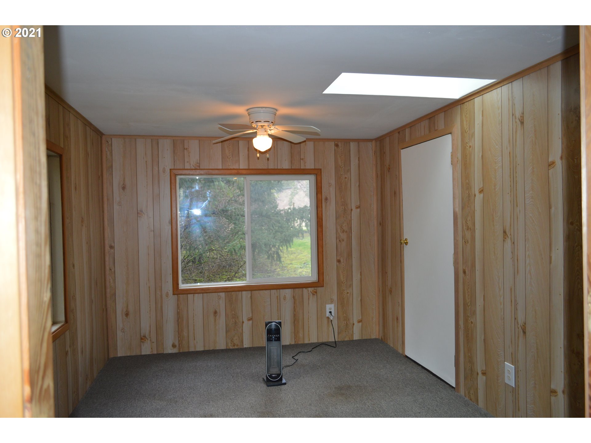 38181 Row River Road Dorena, OR 97434 - Photo 6 of 24 a view of an empty room with wooden floor and a window