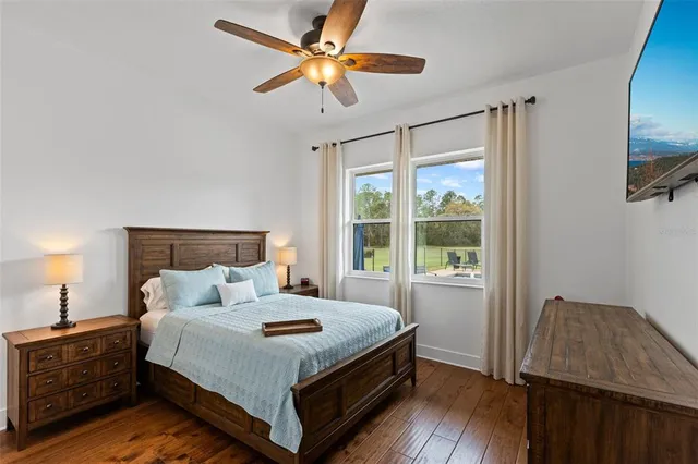 a bedroom with a bed and a large window