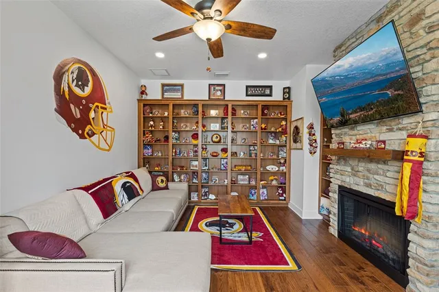 a living room with fireplace furniture and a flat screen tv