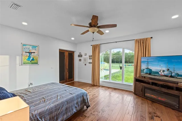 a bedroom with a bed and a dresser next to a window