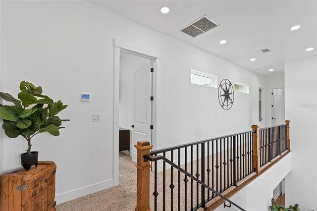 a view of hallway with wooden floor