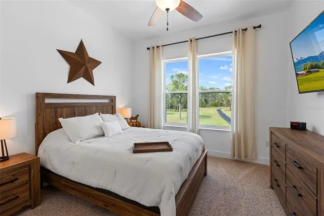 a bedroom with a bed dresser and a window